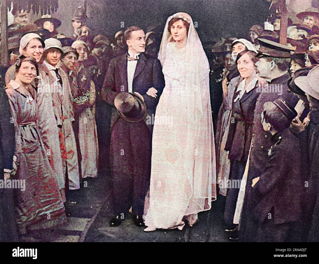 Munition workers forming a guard of honour at the wedding of Miss Stella Drummond to Lord Eustace Percy (third son of the late Duke of Northumberland) at St. Margaret's, Westminster.  Lady Percy was one of a number of society women who worked in the munitions factories.     Date: 1918 Stock Photo