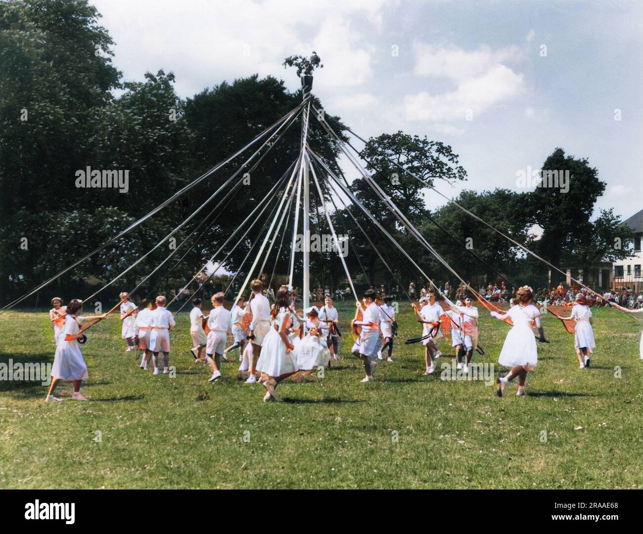 Dancing round the Maypole, a scene at the Ram Roasting Fair, which is held annually on Whitsun Monday at Kingsneignton, Devon, England.     Date: 1950s Stock Photo