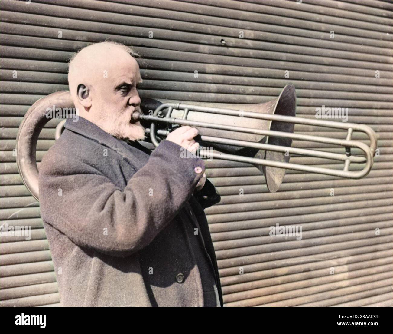 Mr. W.S. Wilkinson of Keighley, Yorkshire, England, is over 80 years old and the only living man who has succeeded in playing this double-slided trombone!     Date: early 1960s Stock Photo