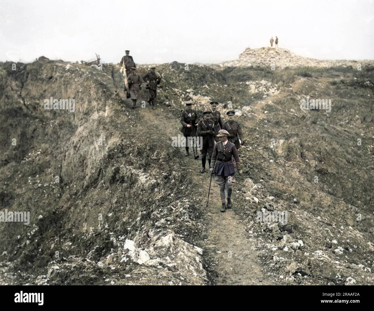 King George V passing between two mine craters near Mametz in The Somme, northern France, in a party guided by Mr Harding of the Royal Engineers.  Others included General Sir H Rawlinson of the 4th Army and Major General W N Congreve of the 13th Corps.     Date: 10-Aug-16 Stock Photo