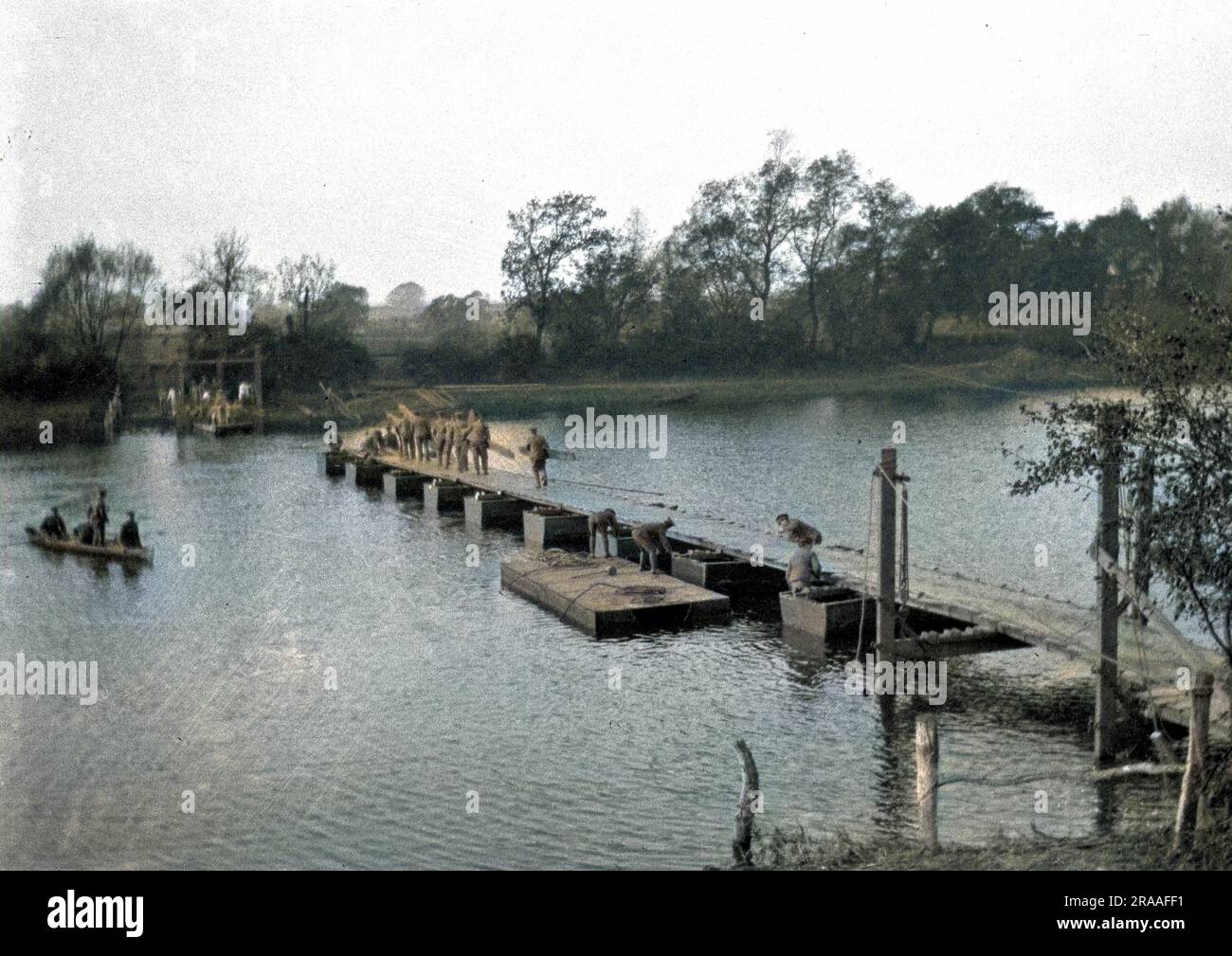 Soldiers constructing a Bailey Bridge across a river. Stock Photo