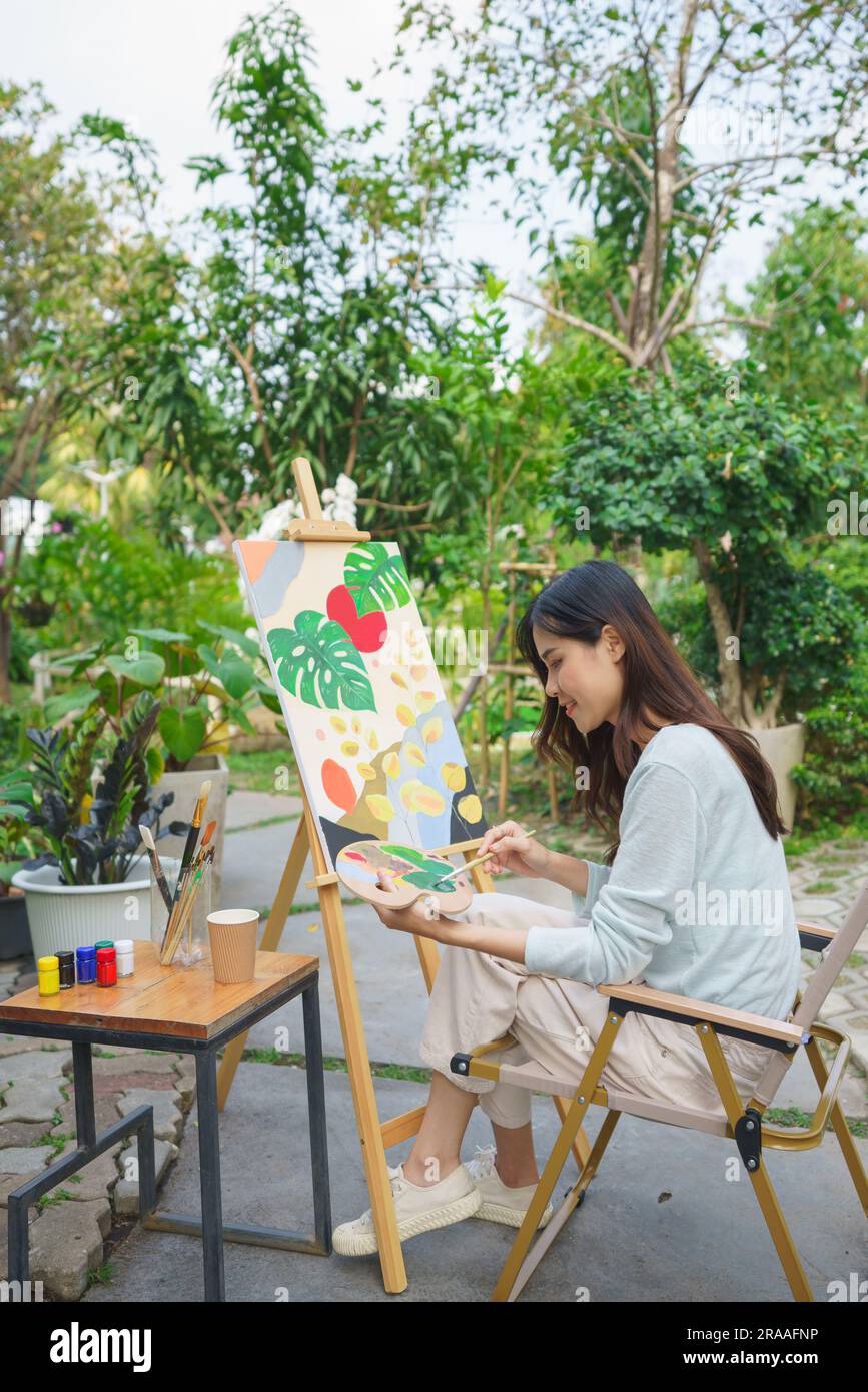 Artist concept, Female artist use brush to mix color on palette for ...