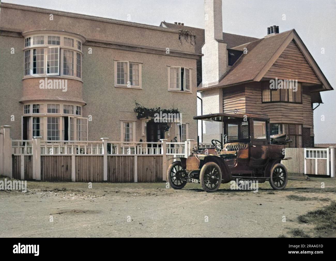 An early car parked in front of a house Stock Photo - Alamy