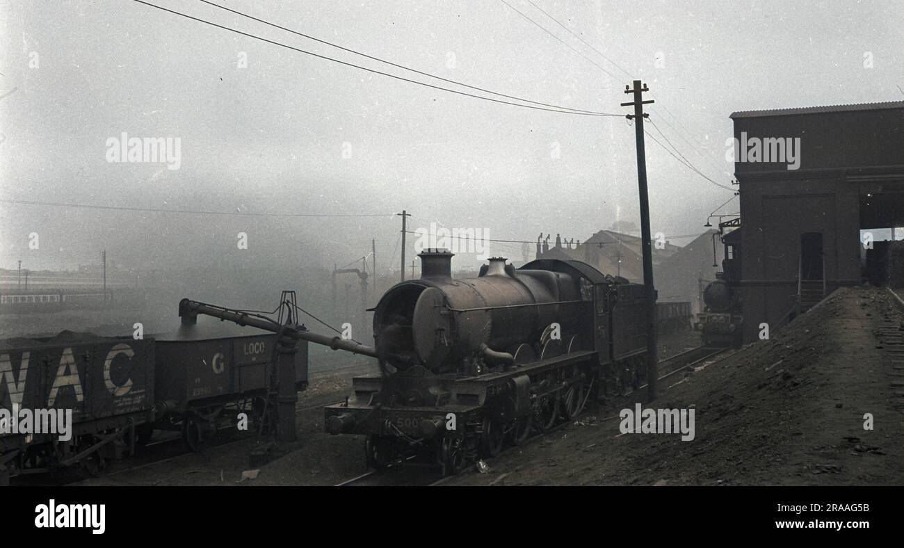 Steam engine and tender in a smoky, polluted atmosphere. Stock Photo
