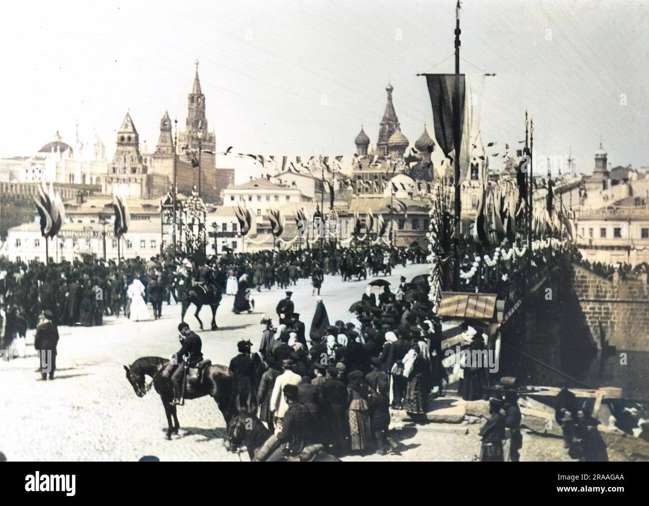Tsar Nicholas II of Russia was crowned on the 26th of May 1896, this parade on the Kamenny Bridge in Moscow, is a small glimpse of the celebratory mood said to have captivated the Russian people.     Date: 26th May 1896 Stock Photo