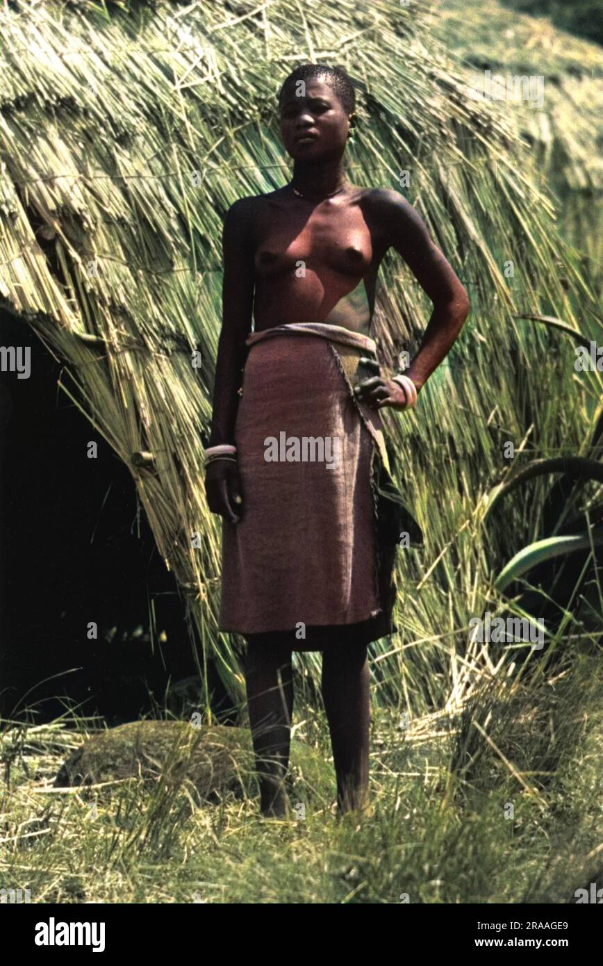A Zulu woman stood outside a straw hut.     Date: 1936 Stock Photo