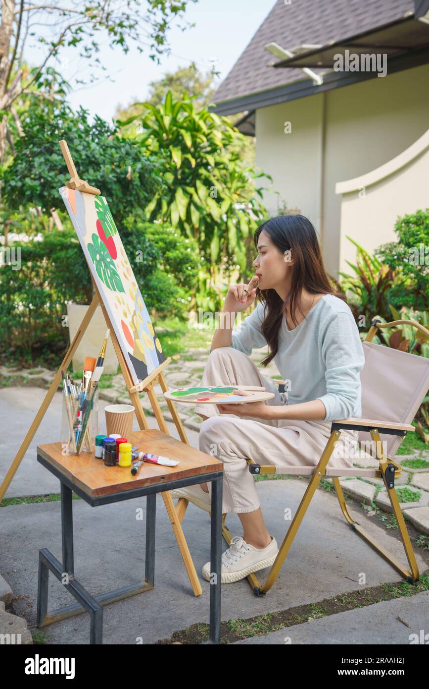 Outdoor activity concept, Female artist thoughtful and looking on ...