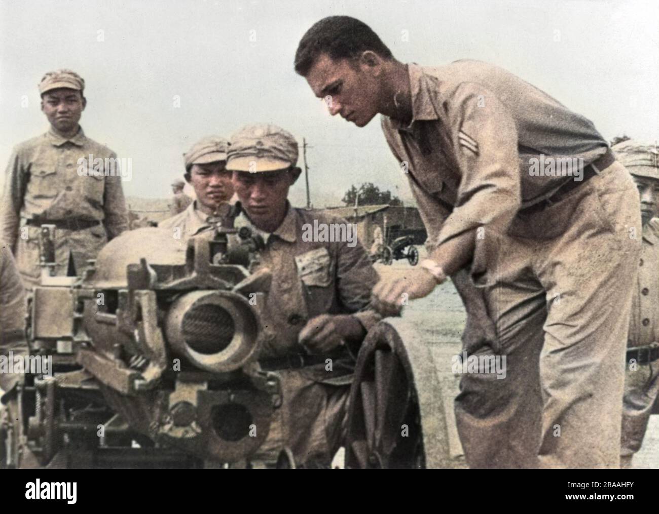 At a base in India, An American corporal trains a Chinese gun crew to