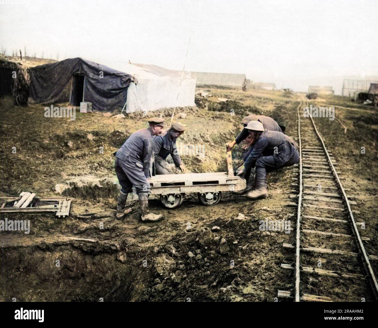 British soldiers working alongside a light railway on the Western Front in France during World War One.     Date: circa 1916 Stock Photo