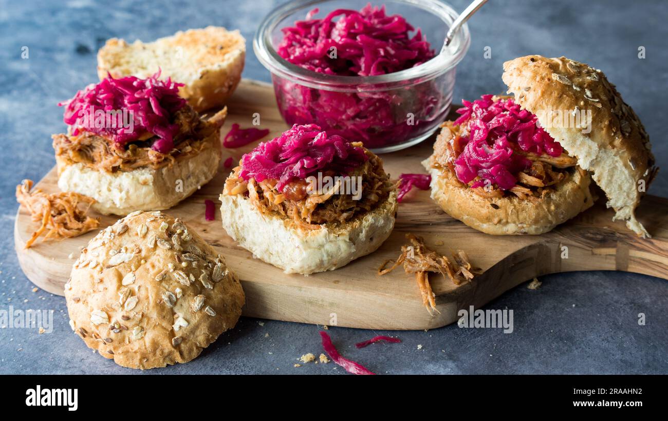 Toasted pulled pork buns topped with pickled beet and cabbage