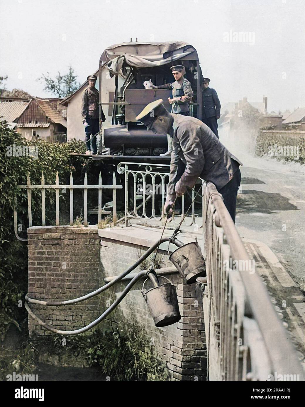 Purifying river water for the consumption of British troops on the Western Front in France during World War One. Poisons are removed, the water is sterilised and is held in a canvas cistern. Lowering pipes into a river.     Date: circa 1916 Stock Photo