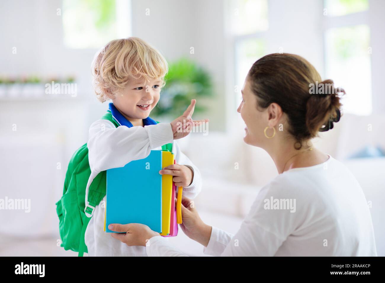 Child going back to school. Mother and kid getting ready for first