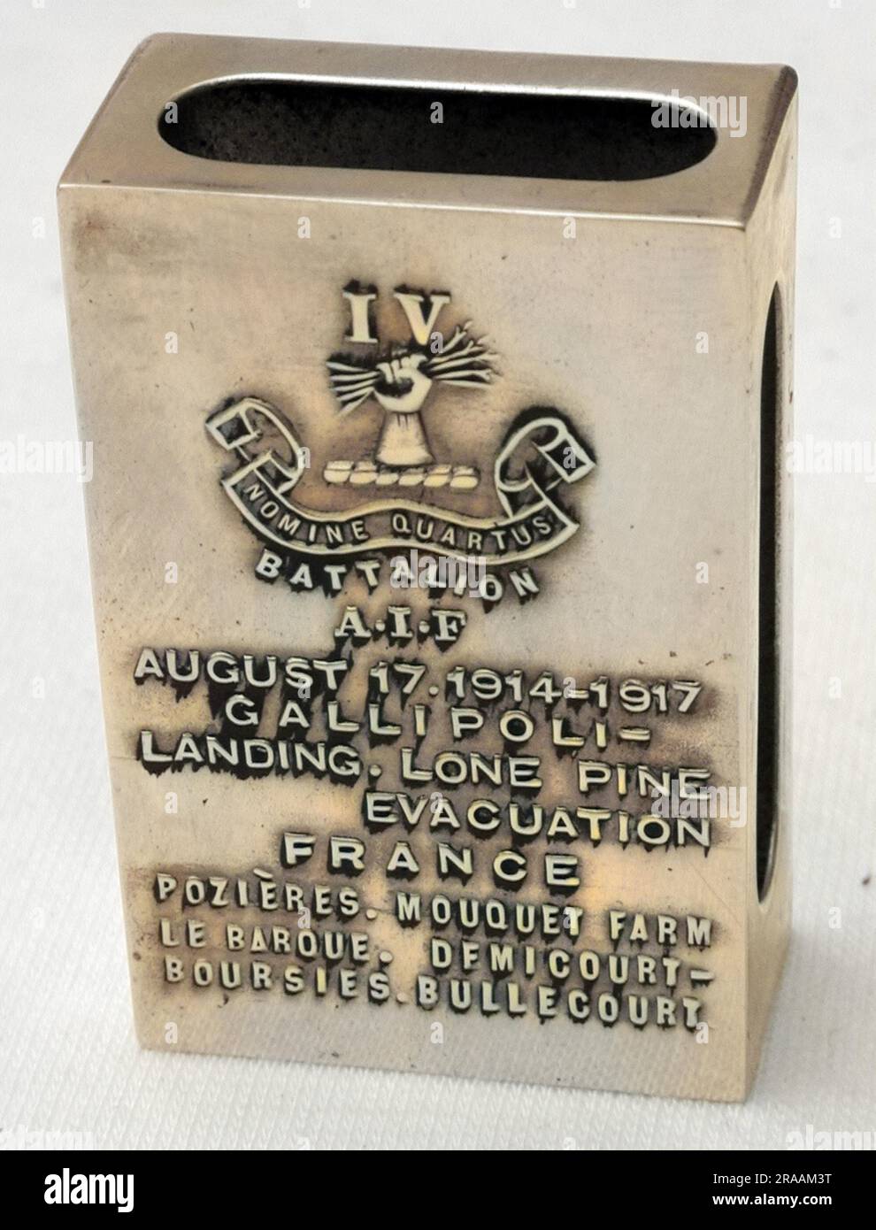 Matchbox holder - made in Birmingham - with the Australian Imperial Force cap badge impressed upon it.  On reverse, commemorating the Battle Honours of the 4th Battalion AIF, dated August 17 1914-1917.  Gallipoli - Lone Pine, France - Pozieres, Mouquet Farm, Le Barque, Demicourt-Boursies, Bullecourt. Trench Art. Stock Photo