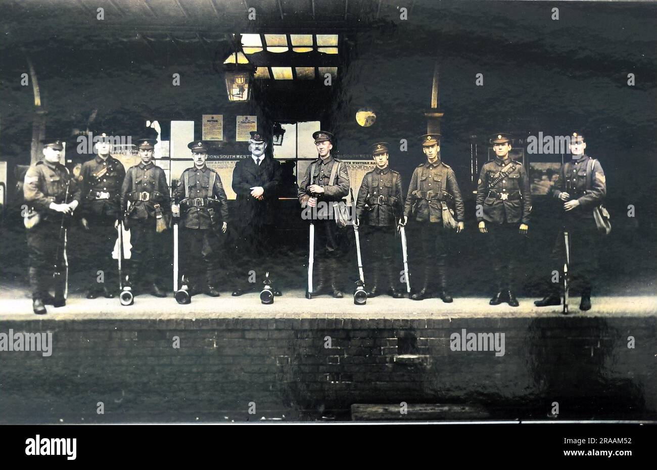 A group of soldiers (Grenadier Guards ') with the Station Master on a platform at Reading Station ('). Photograph Stock Photo