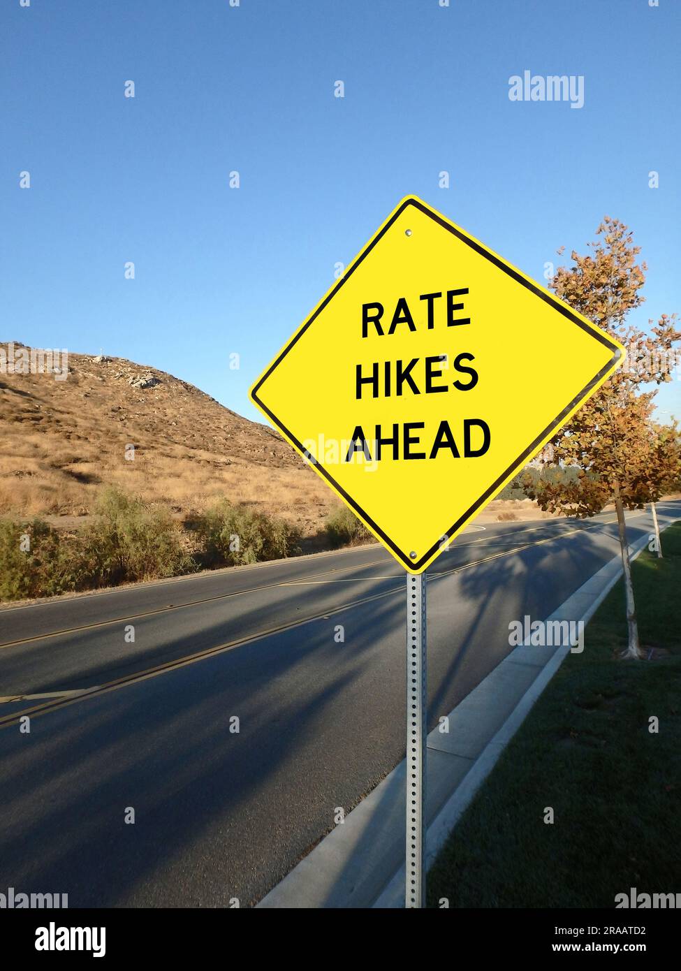 Yellow roadside warning sign warning of interest rate hikes ahead Stock ...