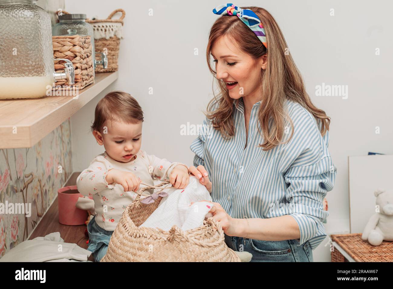 Mom showing her daughter clean washed clothes Stock Photo Alamy