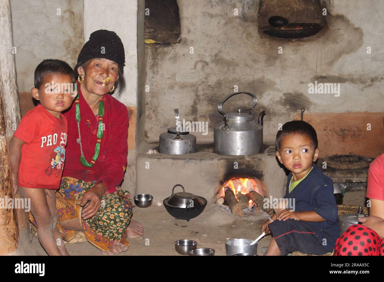 A Nepali Limbu Family having dinner in traditoinal Nepalese Kitchen