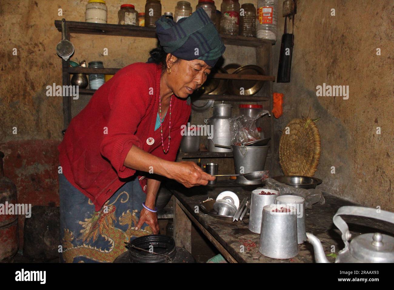 A woman prepares Tongba aka Nepali Beer from fermented millet in a