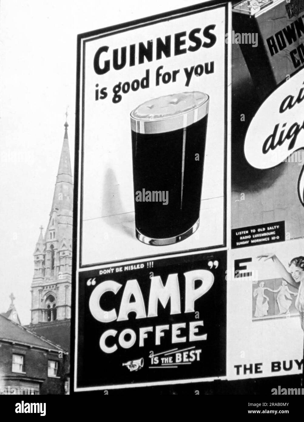 Advertising hoarding for Guinness and Camp Coffee, possibly 1930s Stock Photo