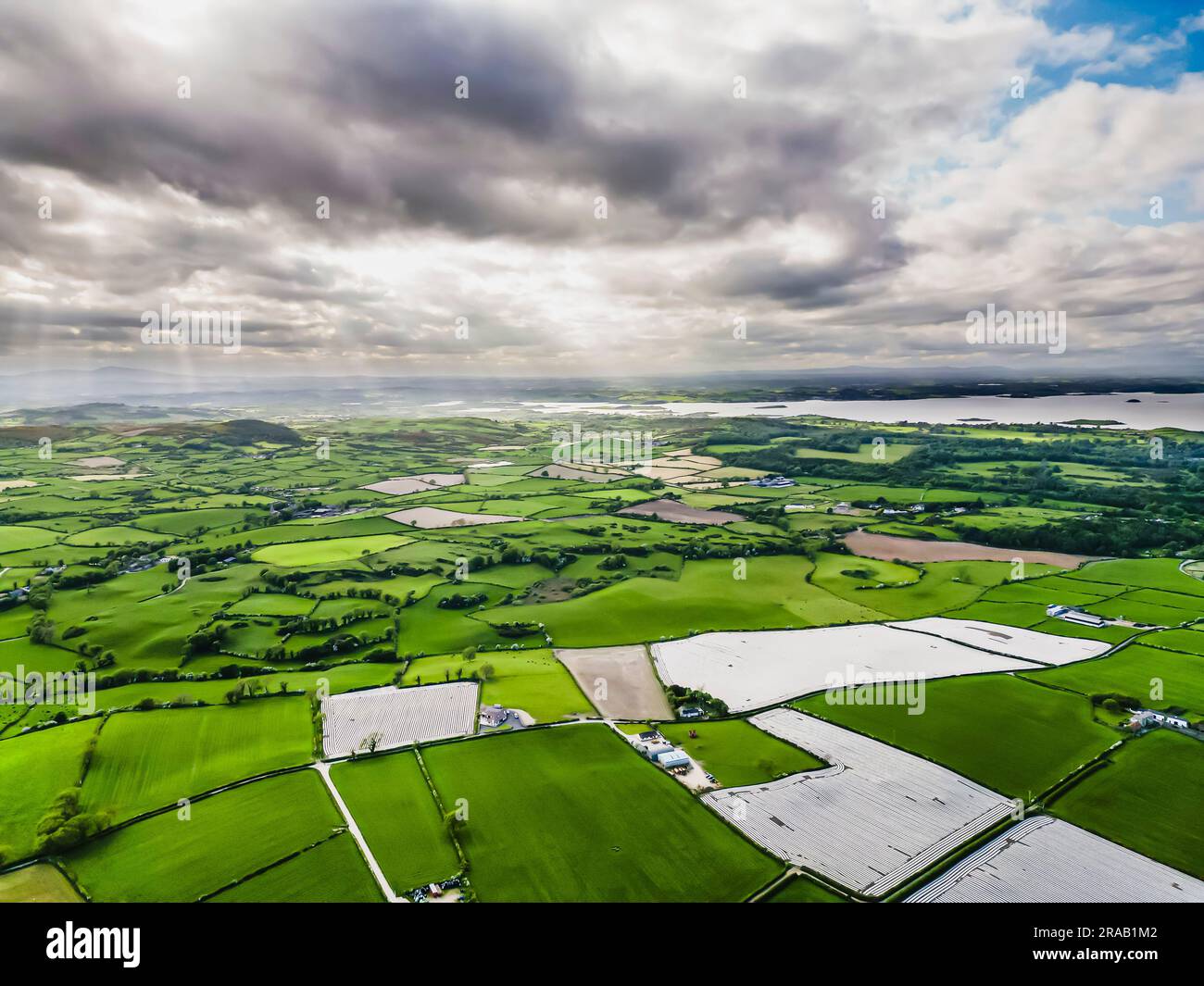 Aerial shot of countryside of south County Down, Northern Ireland, including fields covered in plastic sheeting to protect maize seedlings. Stock Photo