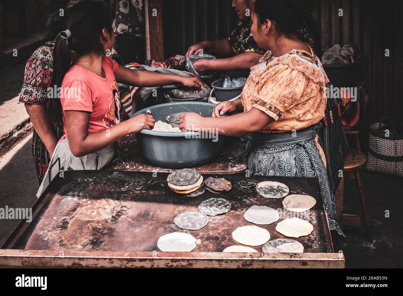 Guatemalan, mayan women making tortillas in traditional way on market in Chichicastenango, Guatemala Stock Photo