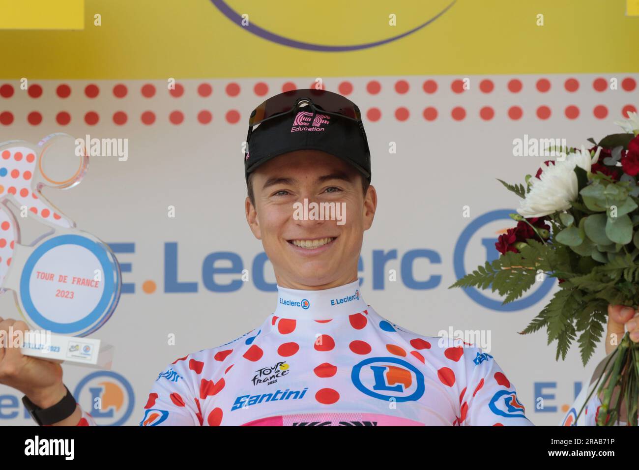 Neilson Powless, USA, EF team smiling on podium with white and red king of the mountains jersey aka the maillot a pois rouge Stock Photo