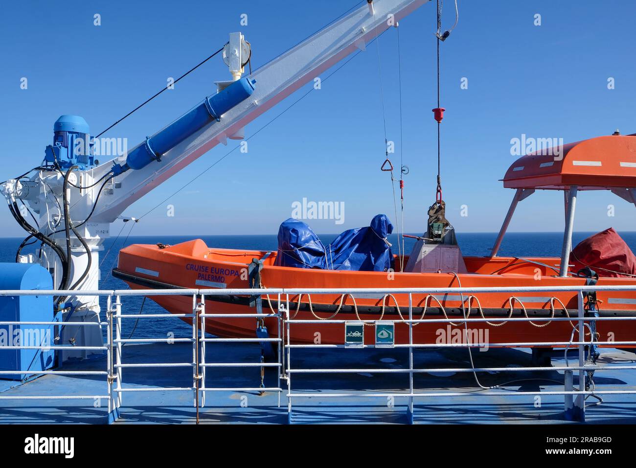 Orange lifeboat onboard a ferry with lifting crane Stock Photo Alamy