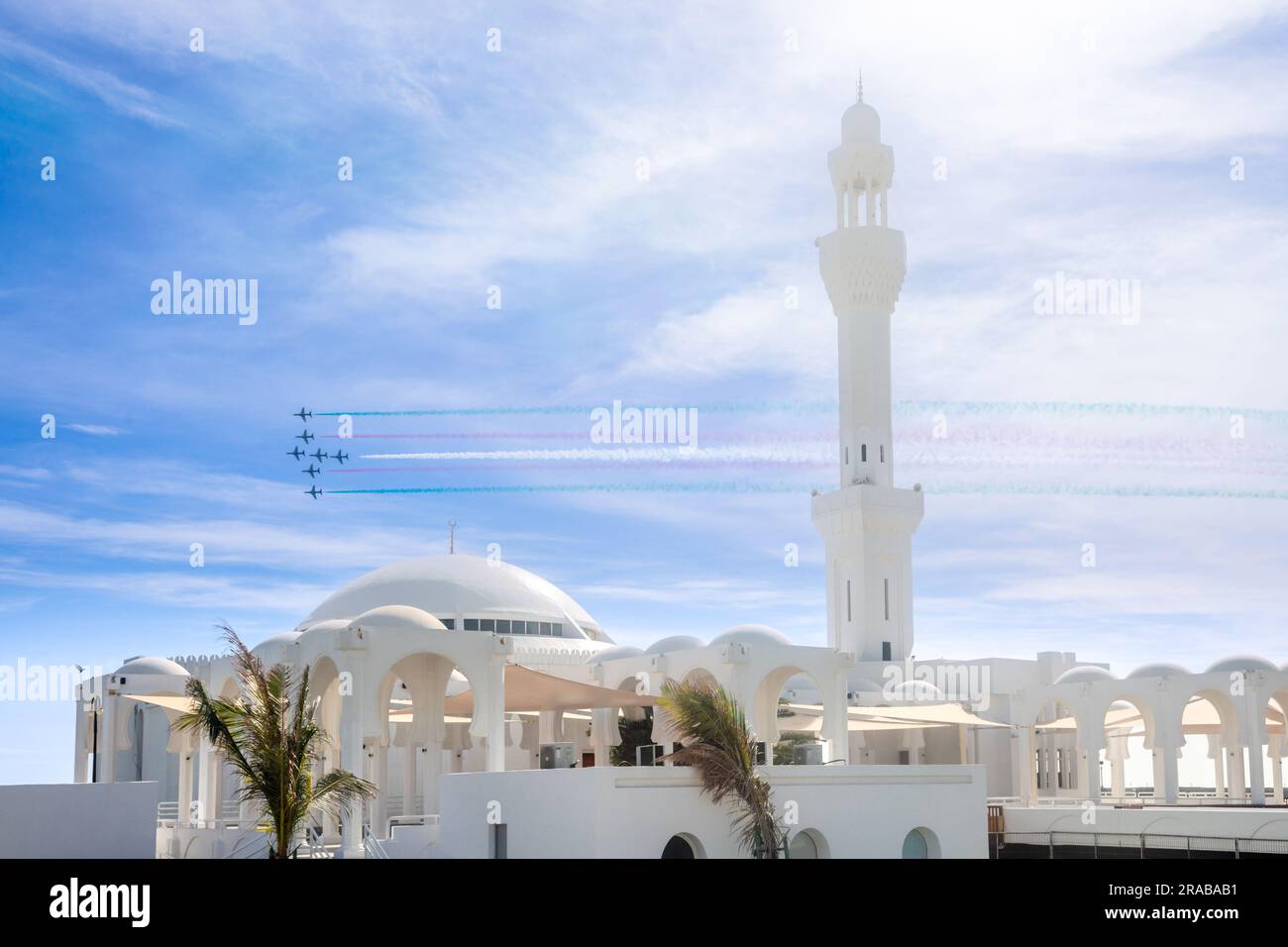 Fighter Jets Squadron with smoke traces over Alrahmah mosque, Jeddah, Saudi Arabia Stock Photo