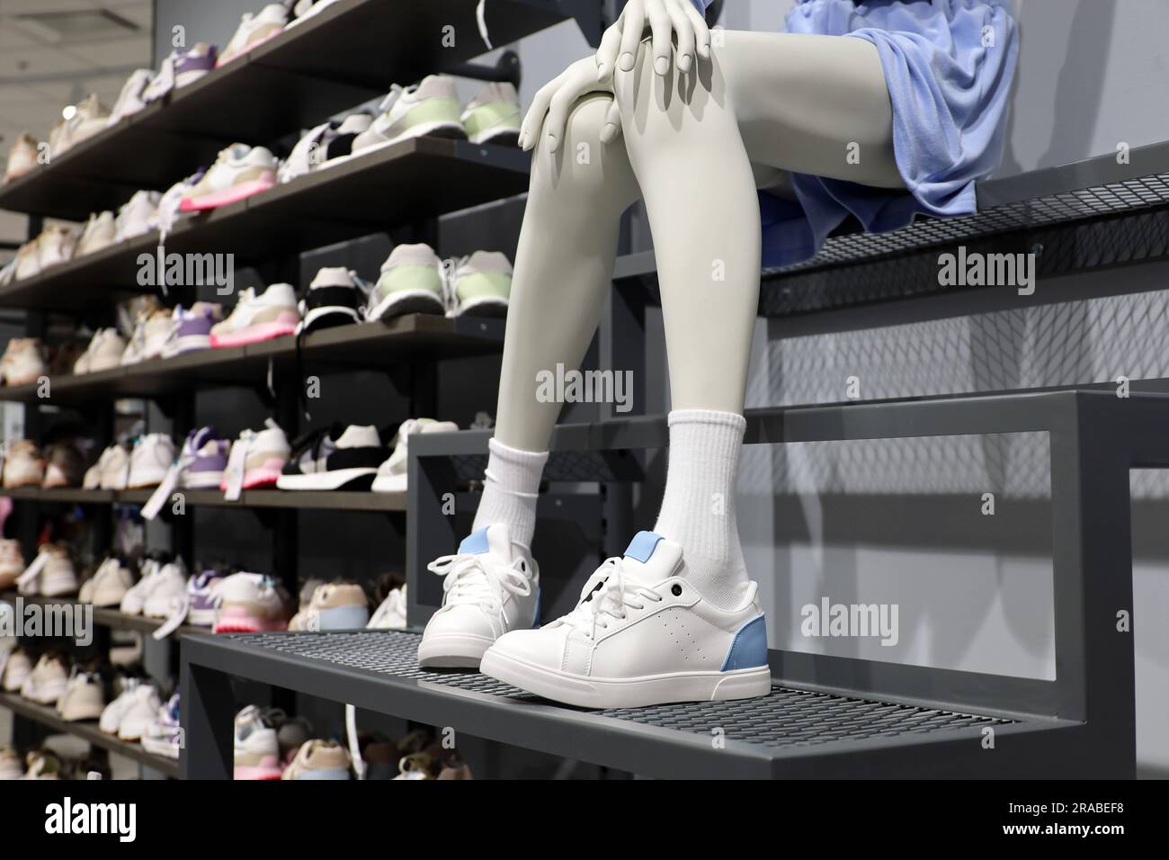 Female sneakers on mannequin in footwear store. Different summer shoes for sports and walking Stock Photo