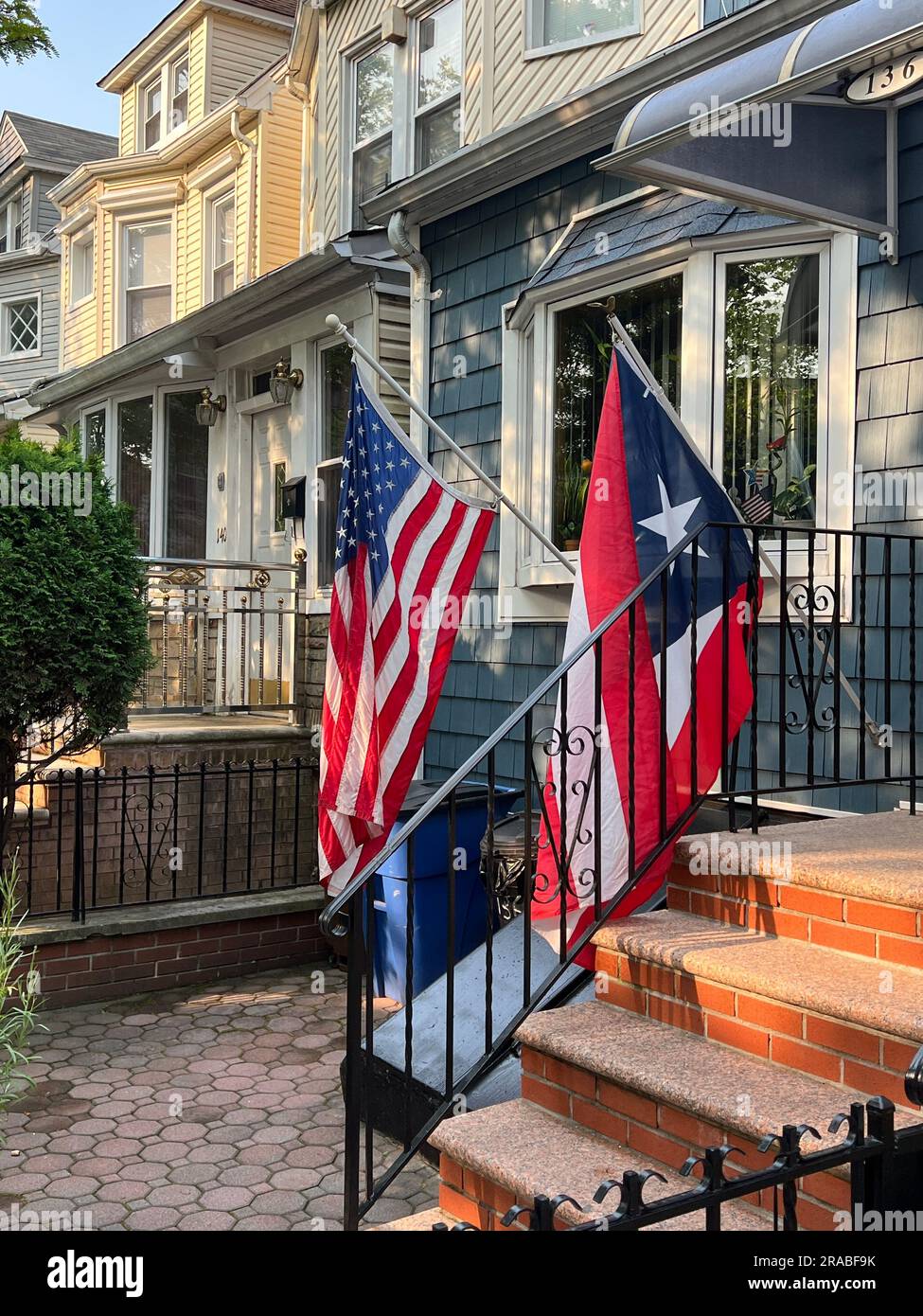 Both American and Puerto Rican flags being displayed at home on a residential street in the Kensington neighborhood of Brooklyn, New York. Stock Photo