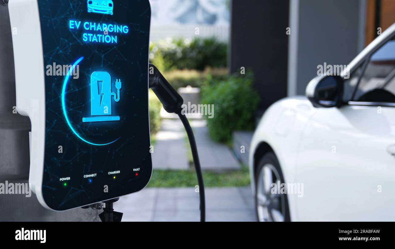 Electric car plugged in with home charging station to recharge battery