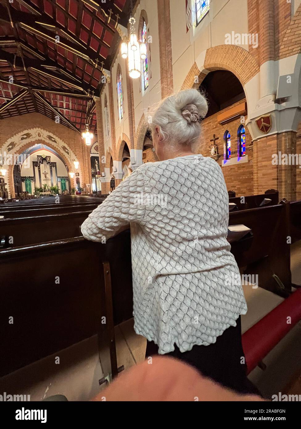 Woman in prayer, Catholic CHurch, Brooklyn, New York.j Stock Photo