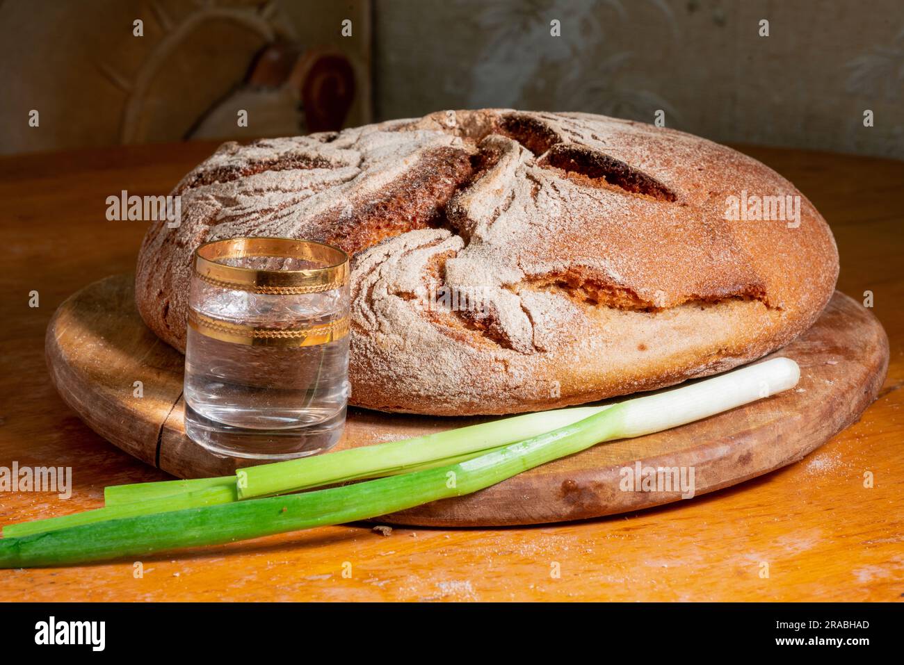 Russian vodka  and rye bread  and  onion feather.  After Russian invasion to Ukraine - increasion of nutrition of alcohol in Russia Stock Photo