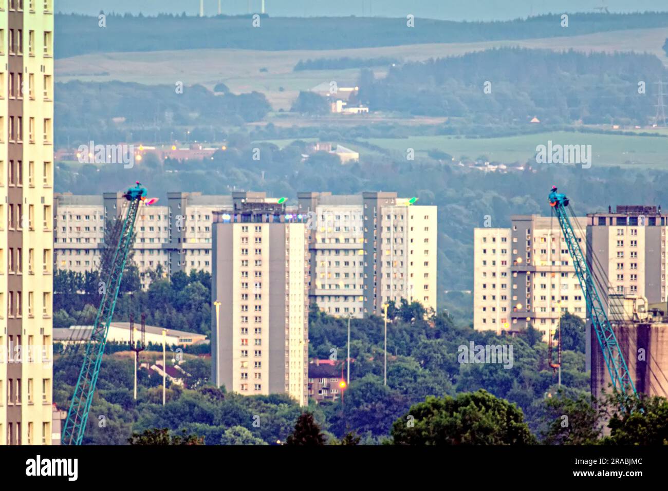 The deprived  Scotstoun council house  towers in the foreground with the poot  high rises of working class  cardonald at the back Stock Photo