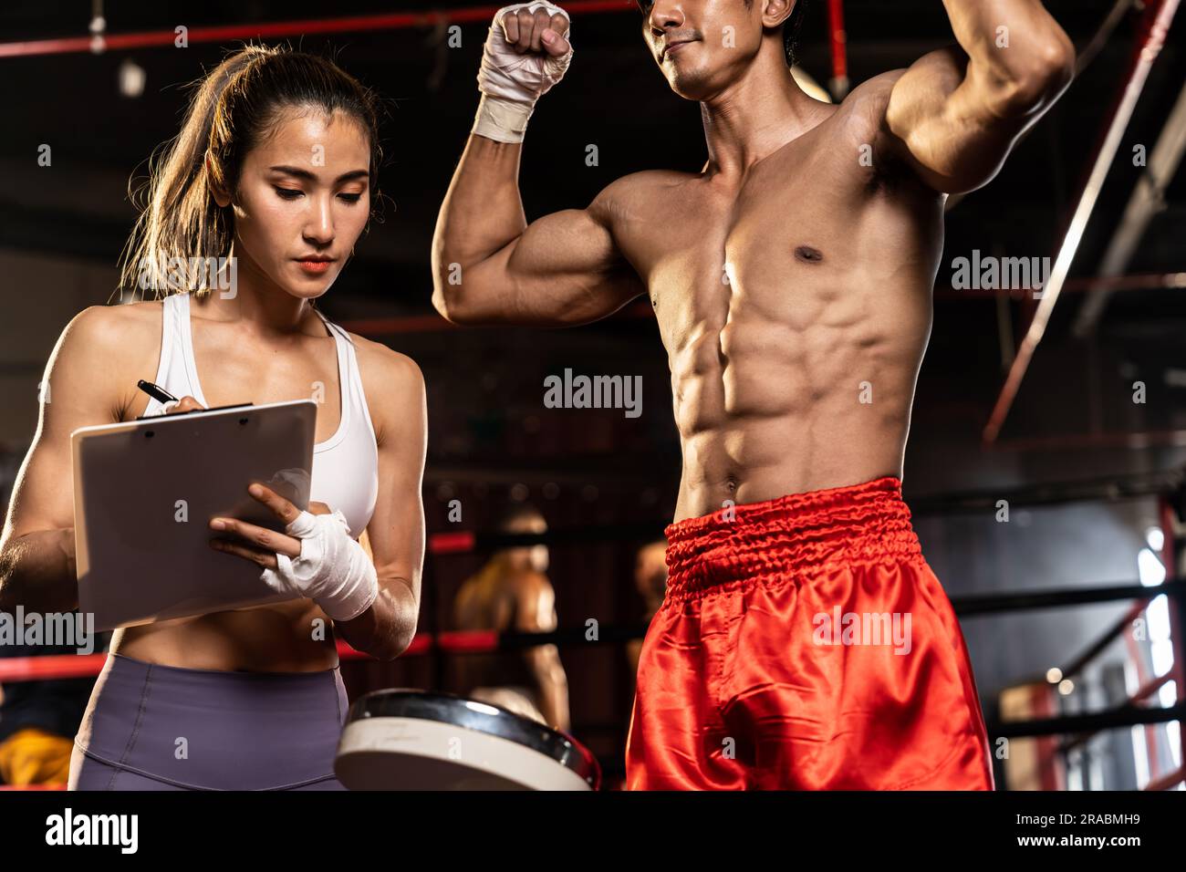 Muay Thai boxer step on weight scale for boxing class designation by