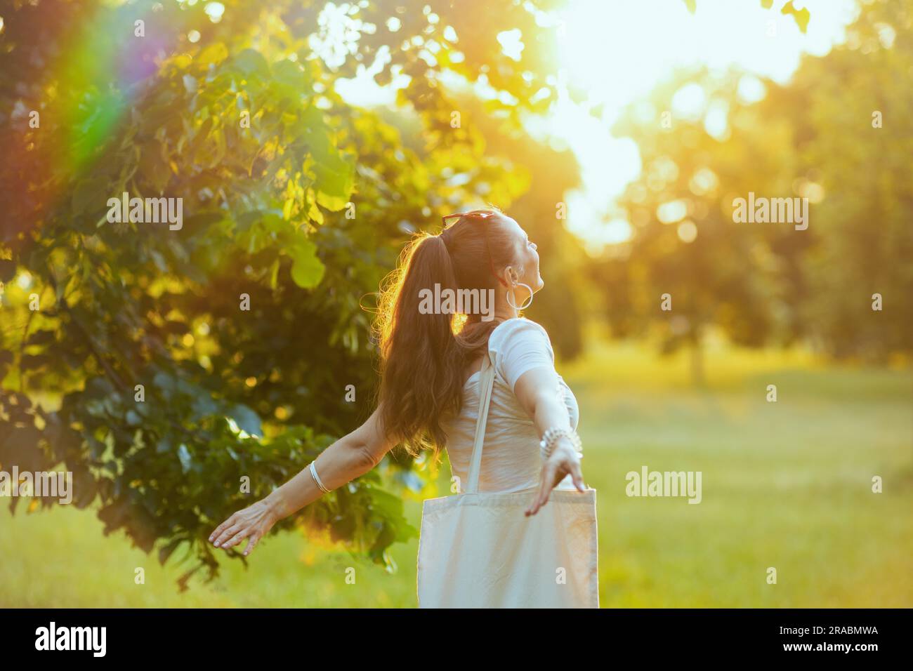 Summer time. smiling modern woman in white shirt outdoors. Stock Photo