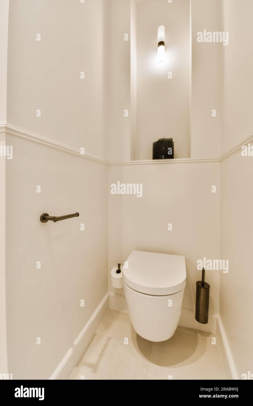 a bathroom with a toilet and mirror above the toilet is not in use, but