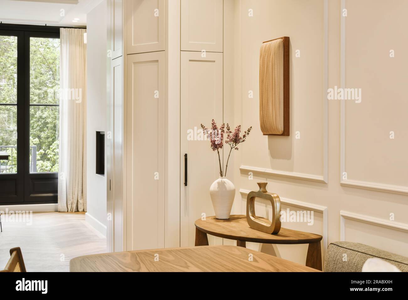 a living room with white walls and wood furniture in the fore - image ...