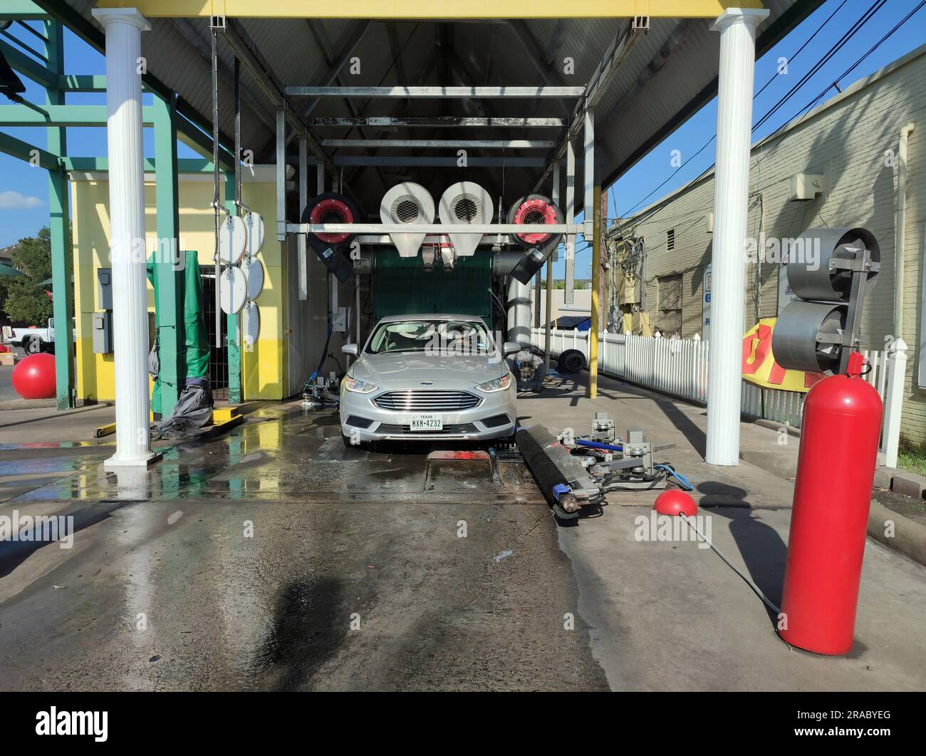 Car washing in progress at an automated car wash centre in Texas Stock