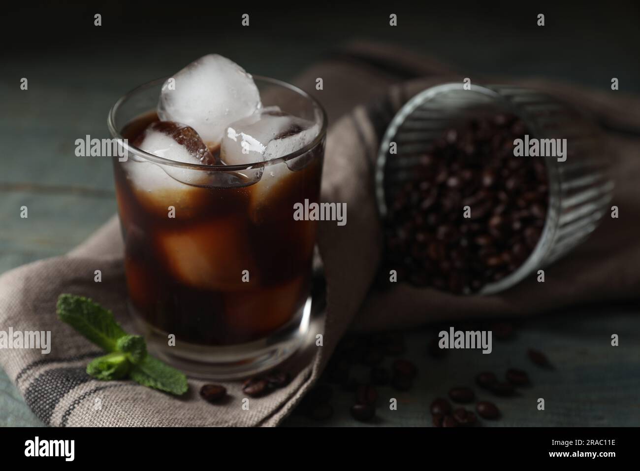 https://c8.alamy.com/comp/2RAC11E/glass-of-delicious-iced-coffee-mint-and-beans-on-table-closeup-space-for-text-2RAC11E.jpg