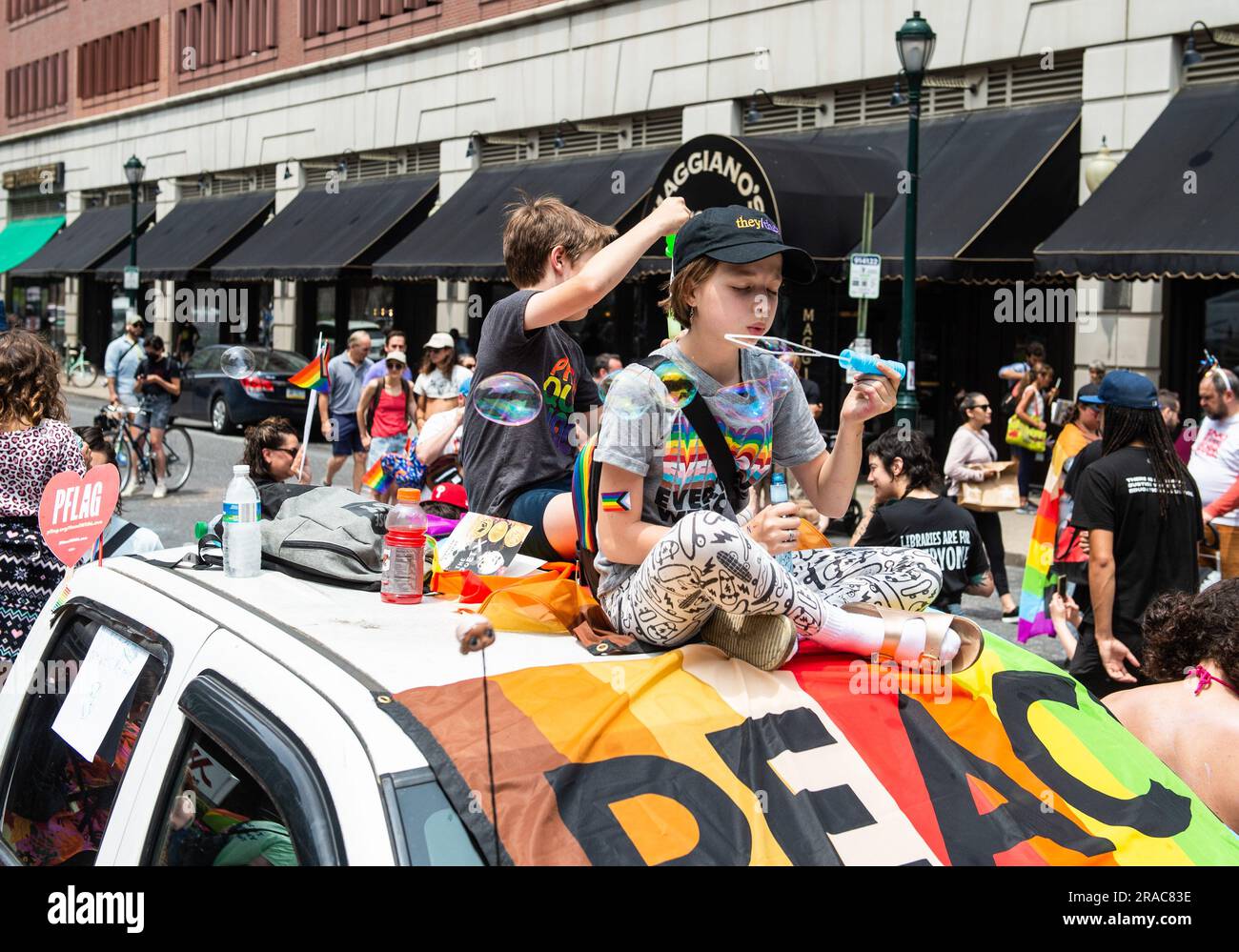 Philadelphia, Pennsylvania, USA. 31st Dec, 2013. Children sit atop a truck and blow bubbles during a protest held by Philly Children's Movement against Moms For Liberty in Center City Philadelphia. Mom's For Liberty, a group from in 2021 to fight against COVID-19 Mandates, held their annual summit in Philadelphia, Pennsylvania and were met by protesters protesting the event and the actions of Mom's For Liberty. The group which is designated by the Southern Poverty Law Center as a hate group, has been a vocal voice in anti-LGBT rhetoric and the push in banning certain books from sc Stock Photo