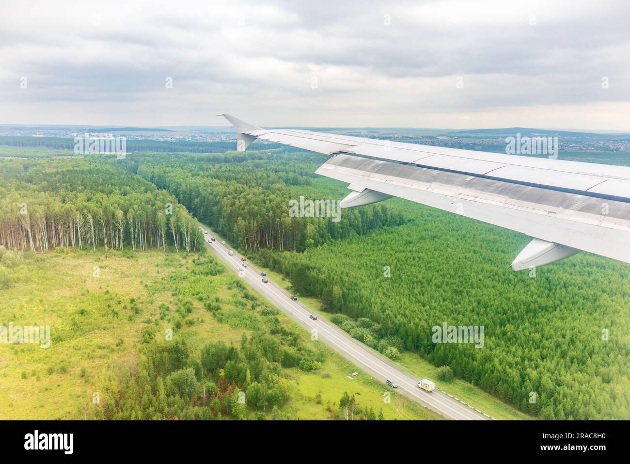 view-of-airplane-wing-blue-skies-and-green-land-during-landing