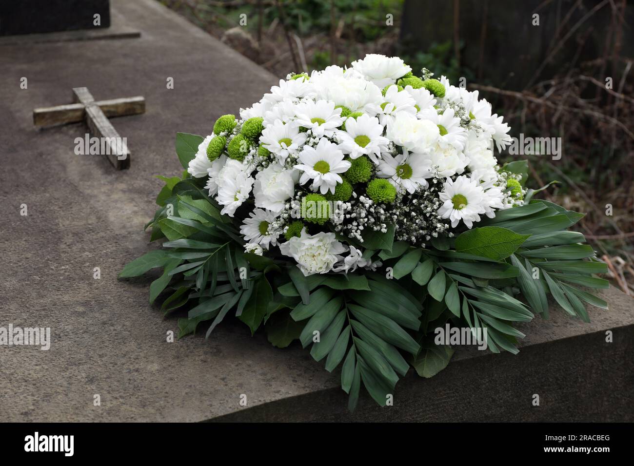 Funeral wreath of flowers on tombstone outdoors Stock Photo Alamy