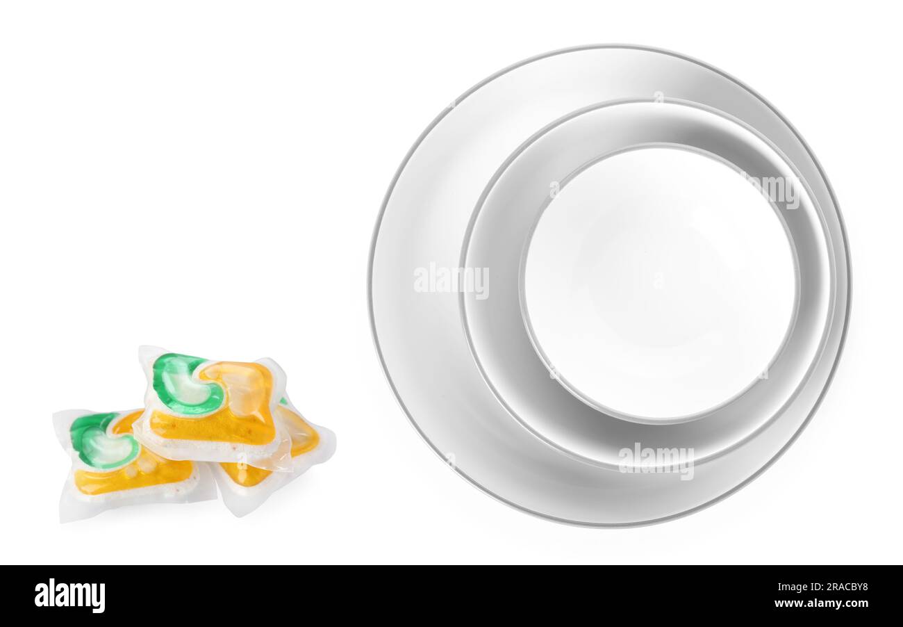 Dishwasher pods and clean dishes isolated on white Stock Photo Alamy