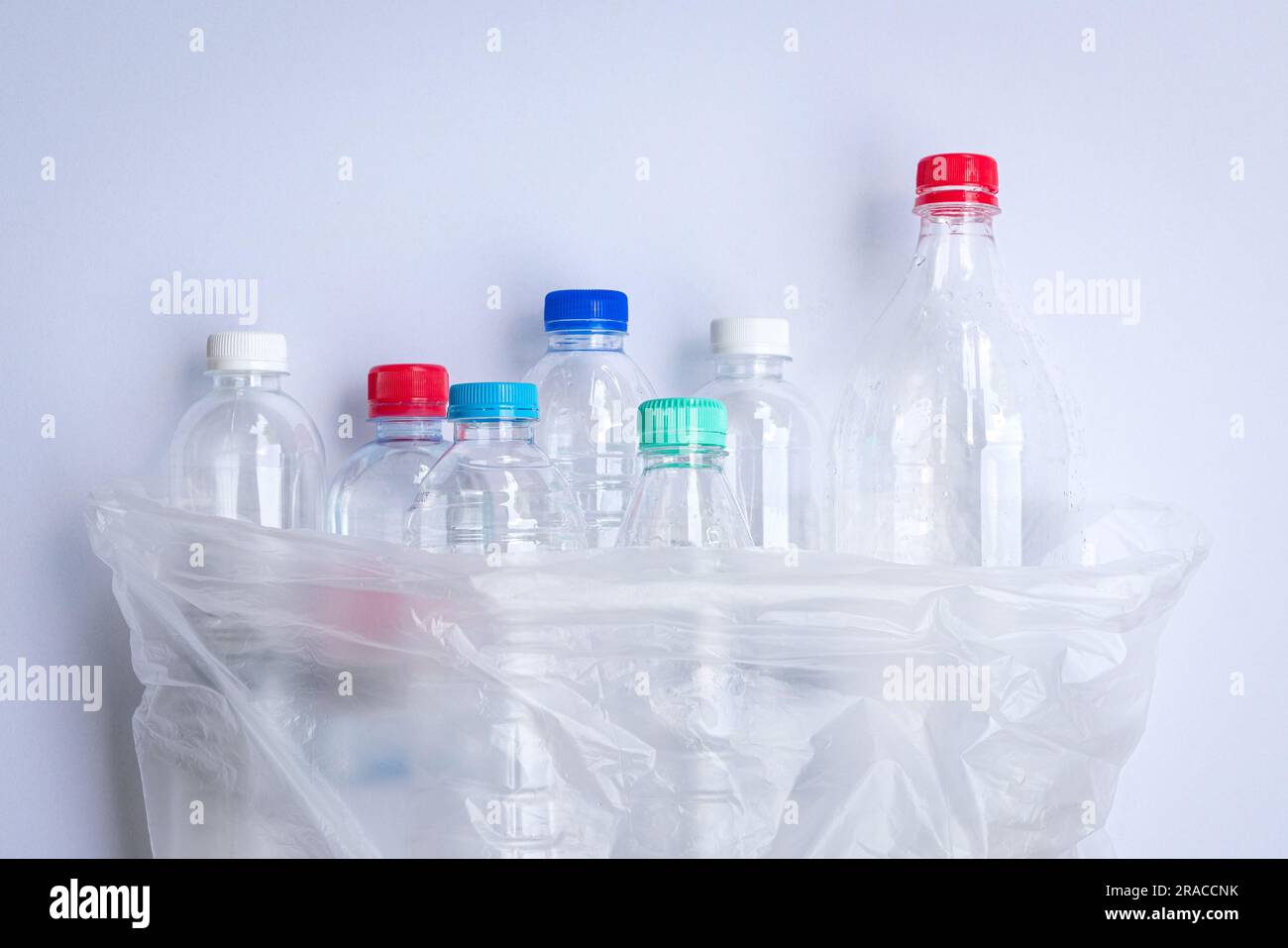 Plastic bottles inside a plastic bag. On white background. Stock Photo