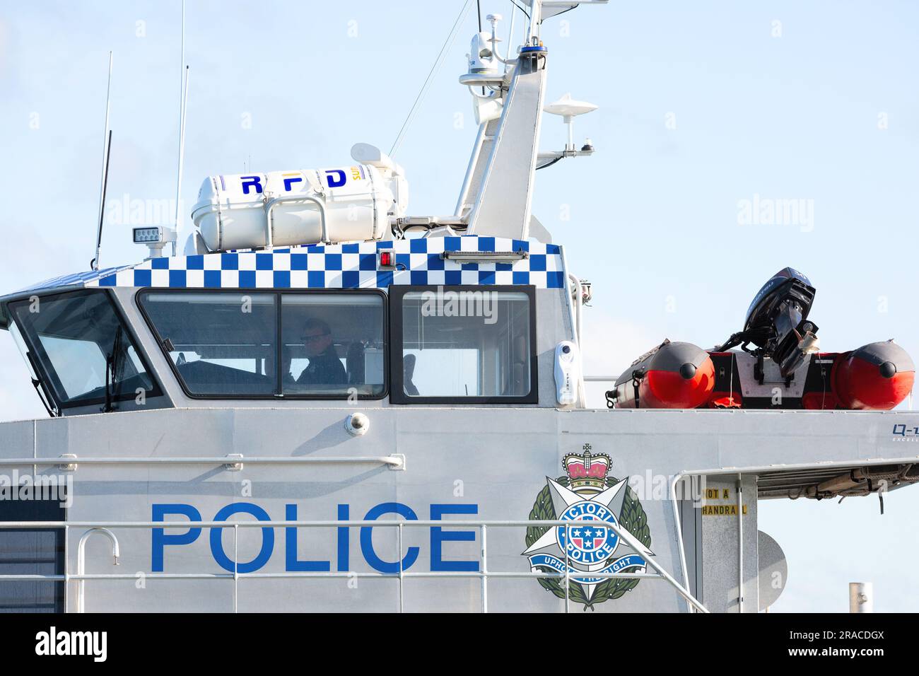 A police boat is seen as a yacht loses her mast during the Winter Series yacht race in choppy seas in Port Phillip Bay, Melbourne Stock Photo