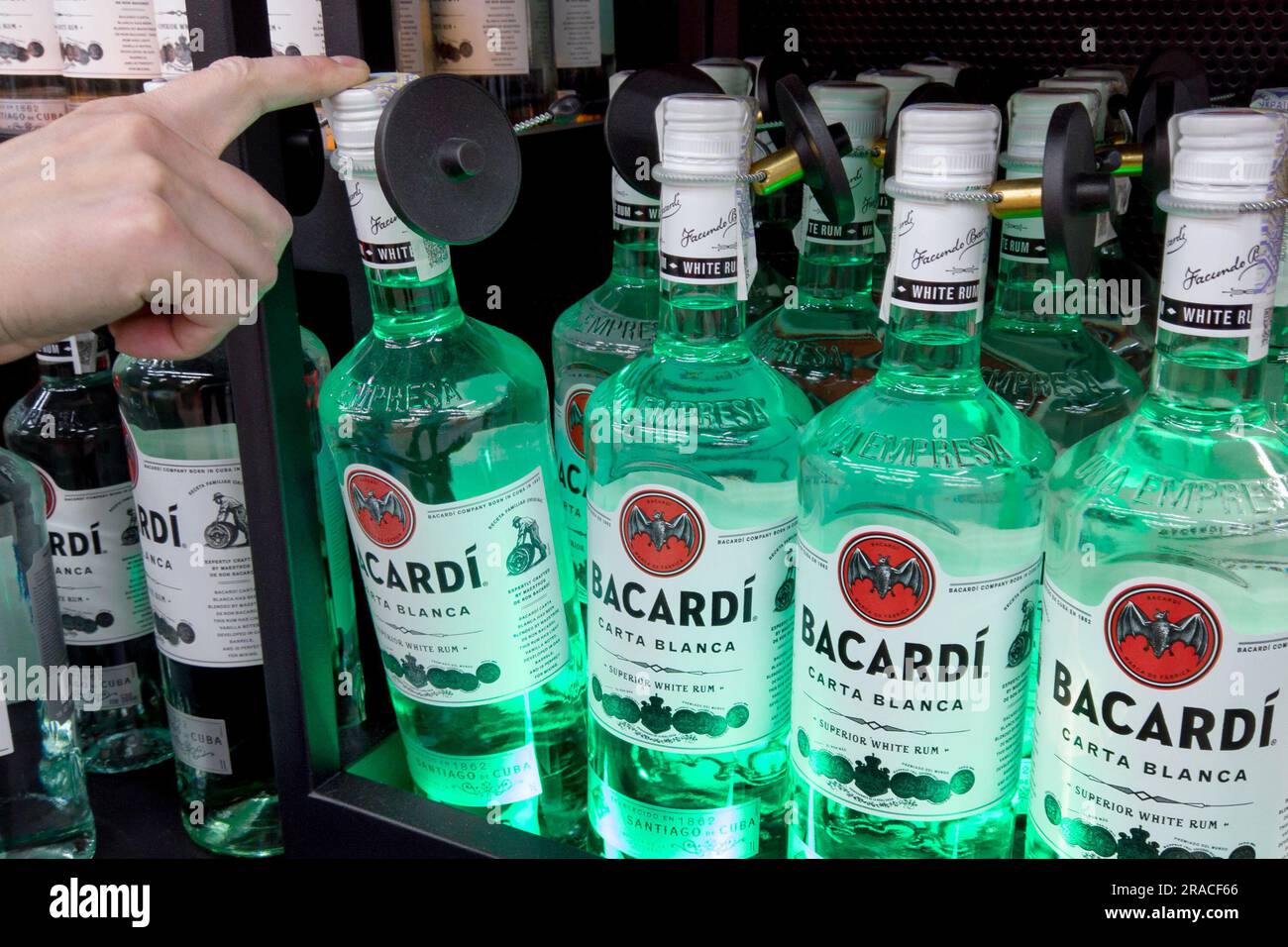 Bacardi rum for sale at a hypermarket. Buyer Hand holding Bacardi white