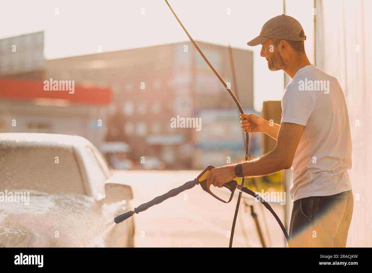Worker washing car at selfservice car wash Stock Photo Alamy