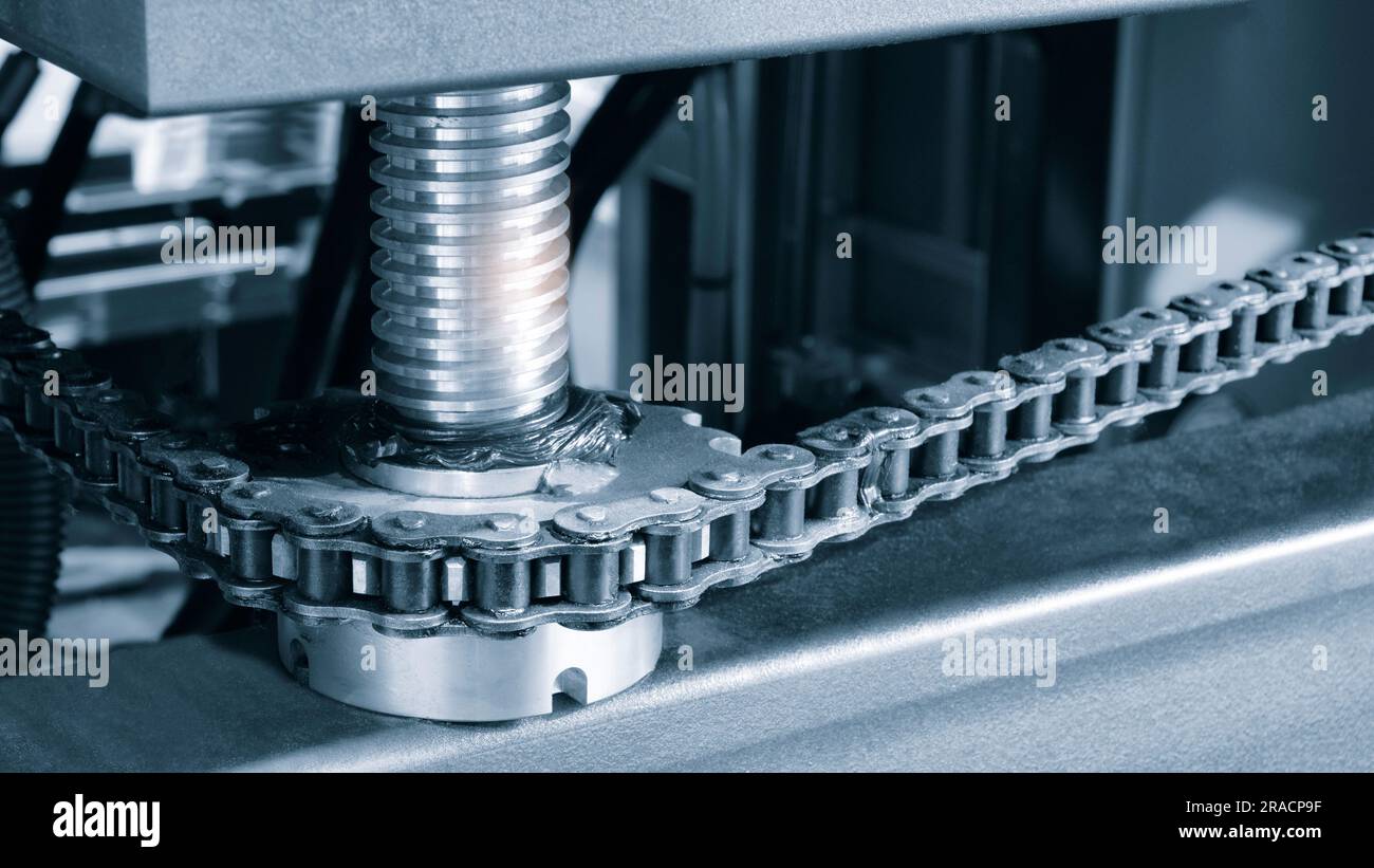 Gear chain drive shaft in conveyor belt is on production line. Timing chain of car, tensioners