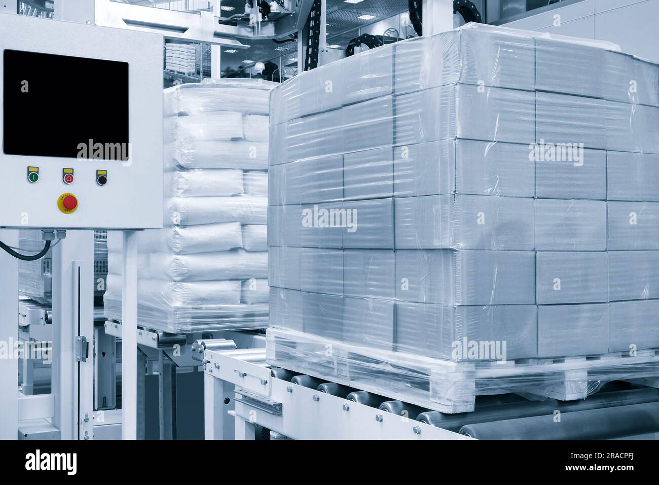 Cardboard boxes on a pallet wrapped in plastic wrap ready for delivery in a warehouse, logistics